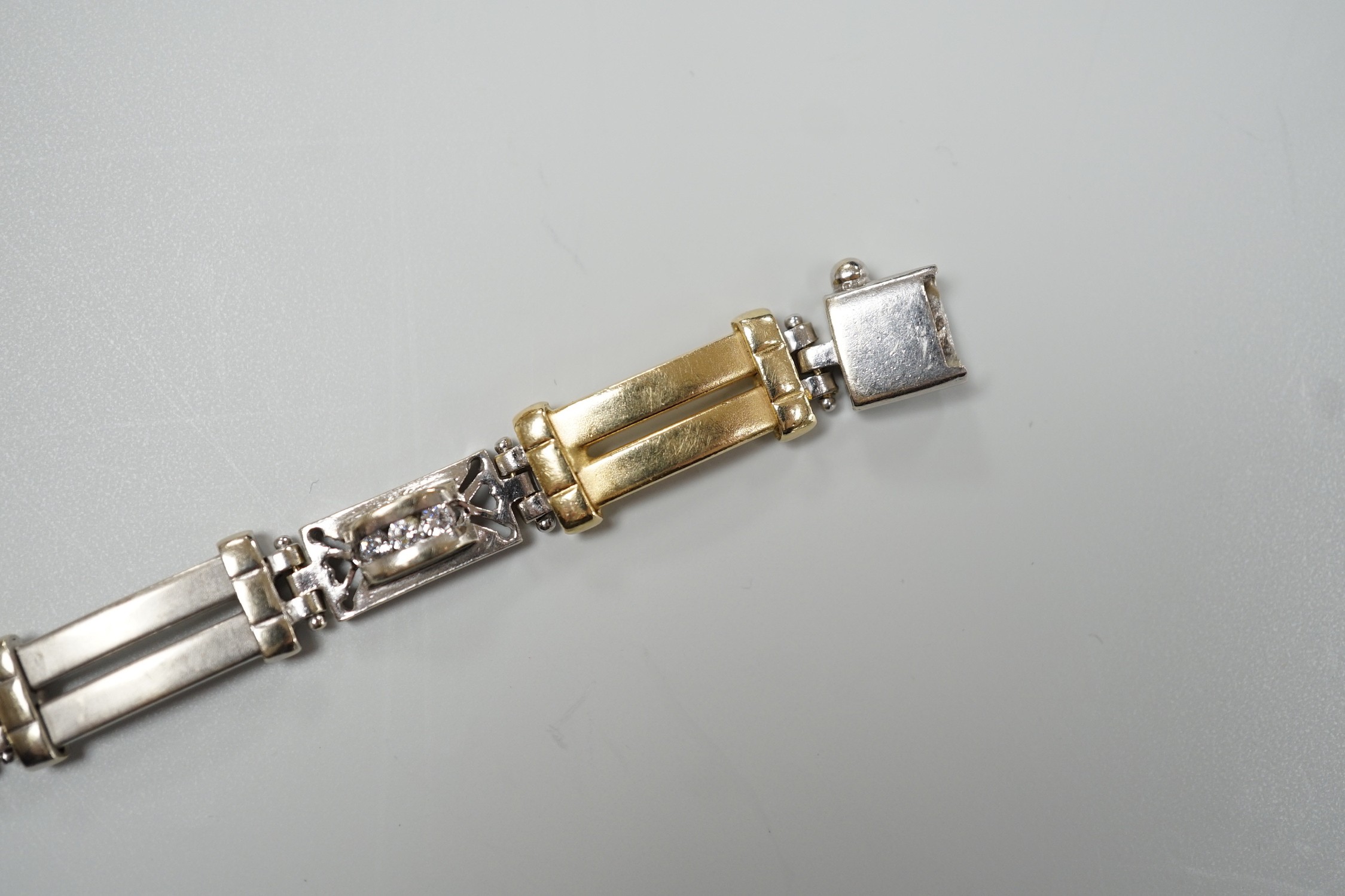 A modern two colour 585 and twelve stone diamond set bracelet, 17.75cm, gross weight 19.2 grams.